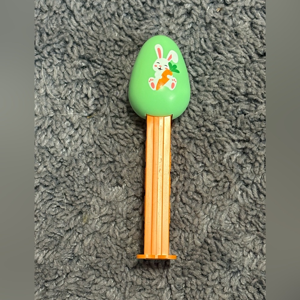 NWOT Orange collectible PEZ dispenser with green egg with a white rabbit design